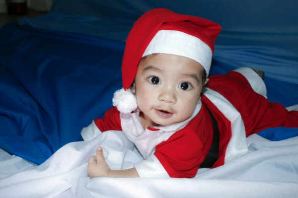A cute baby in a santa suit 