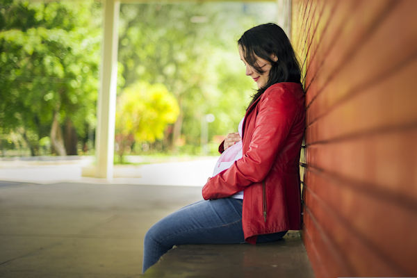 A pregnant woman in a cool leather jacket