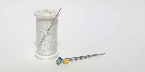 Reel of cotton and a needle