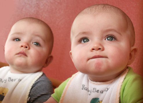 Twins in bibs.